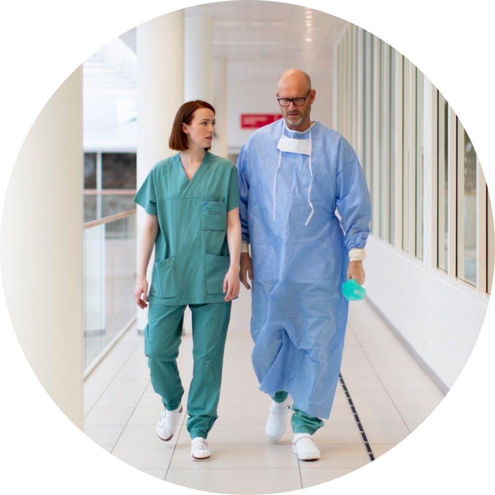Healthcare professionals walking down hospital corridor